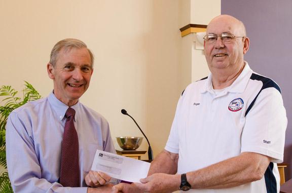 Congregation Pres. George Bauer left:presenting check to Roger Uthoff of Eastern Iowa Honor Fligthts