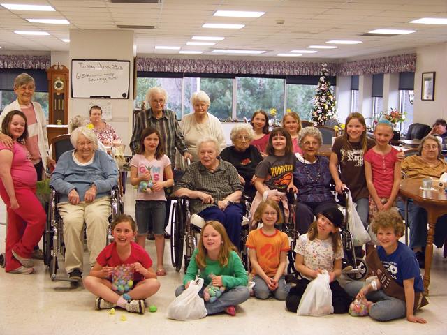 BROWNIE TROUP No. 6081 and the residents of VGH Nursing & Rehab pose for a group photo