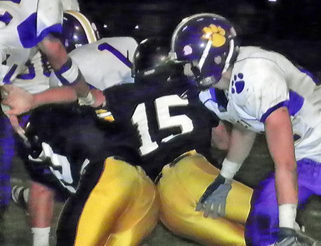 Taylor Rommann (15) helps tackle a Saber runner.