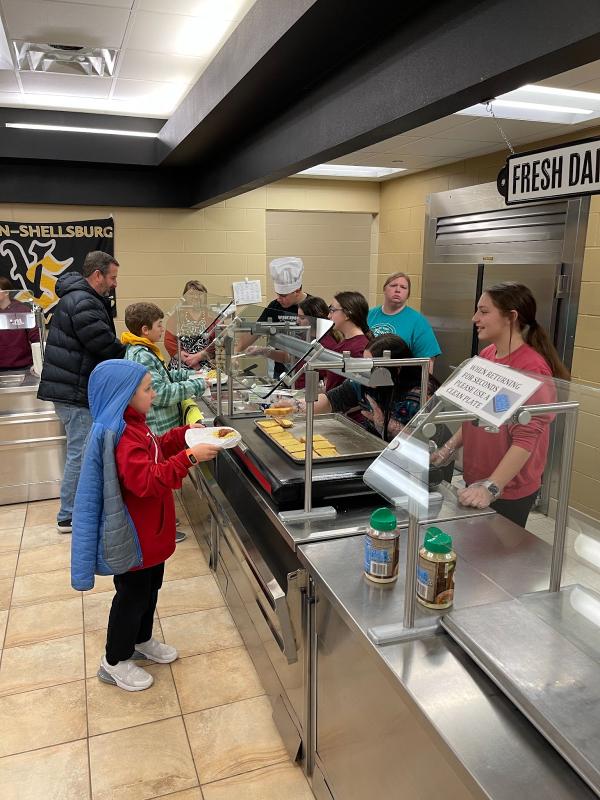  FFA members serving customers as they go through the supper line.