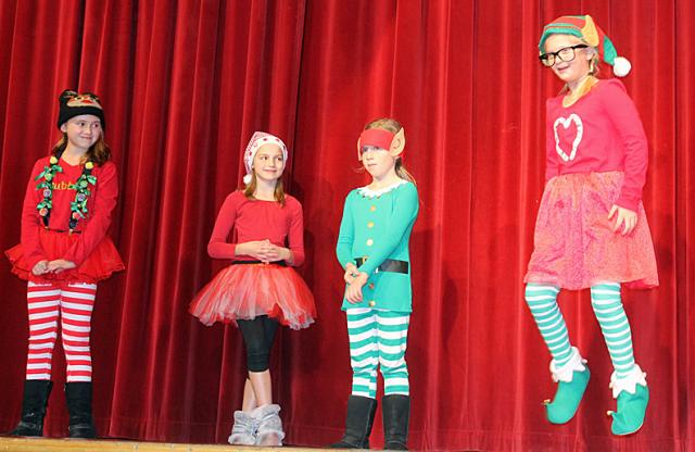 The girl elves celebrate the arrival of a new boy to the North Pole.
