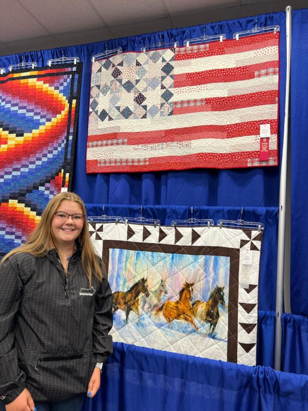 Abby McKenna with her flag quilt which brought home a 2nd Place Ribbon from the Iowa State Fair