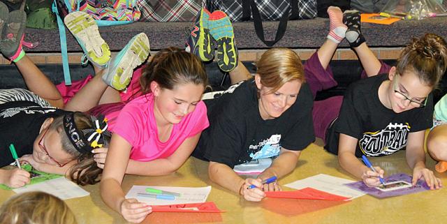 Sole Sisters: Teacher Lindsey Otto and some of the 5th grade girls write compliments to each other.