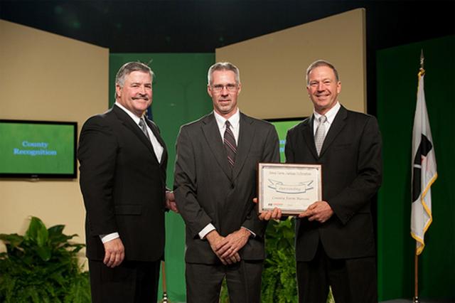 Craig Lang left, David Wrage, Craig Hill, right present award to Wrage