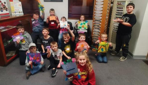 Youth show of their 'Beautiful Oops' artwork after experiencing an Art and Literacy 4-H program.