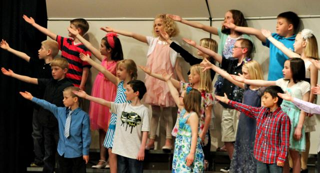 Second graders honor 'The Grand Old Flag' during their concert Thursday evening at Tilford.