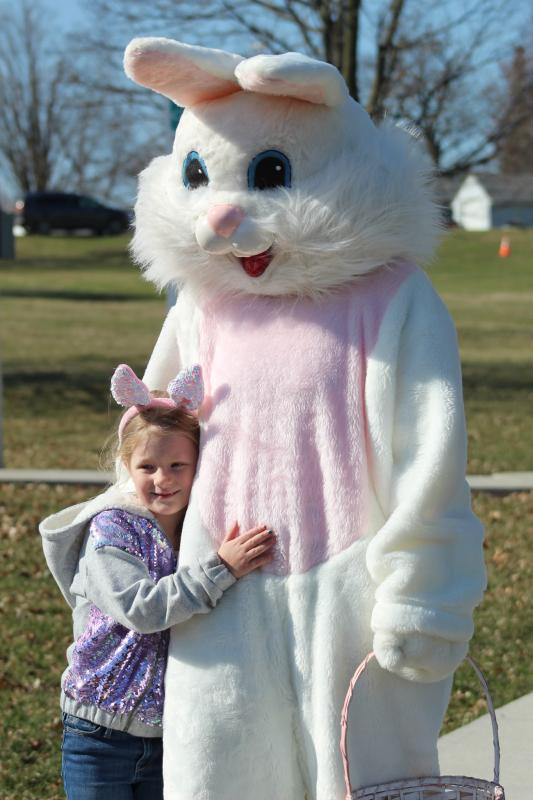 The Easter Bunny gets a hug from one of the bunny's tiny fans 