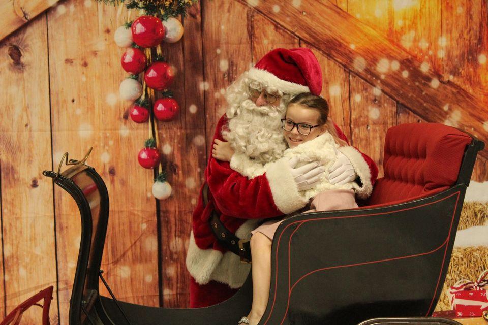 Santa gets a hug at the Breakfast with Santa event