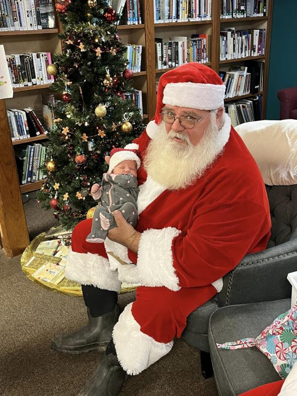 Santa visits with his youngest child at the Shellsburg Public Library.