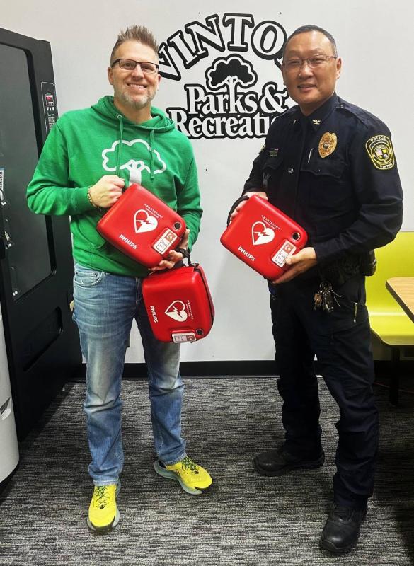 Vinton Police Chief Ted Paxton presents new AED units to Vinton Parks and Rec Director Matt Boggess