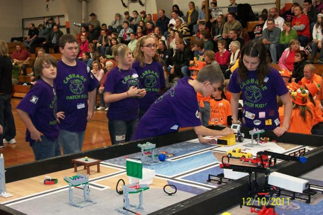 The Cabbage Patch Kids and their robot in action.