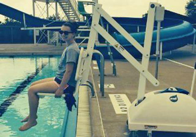 Swimming Pool Assistant Manager Claire Andreesen demonstrates the portable aquatic lift.