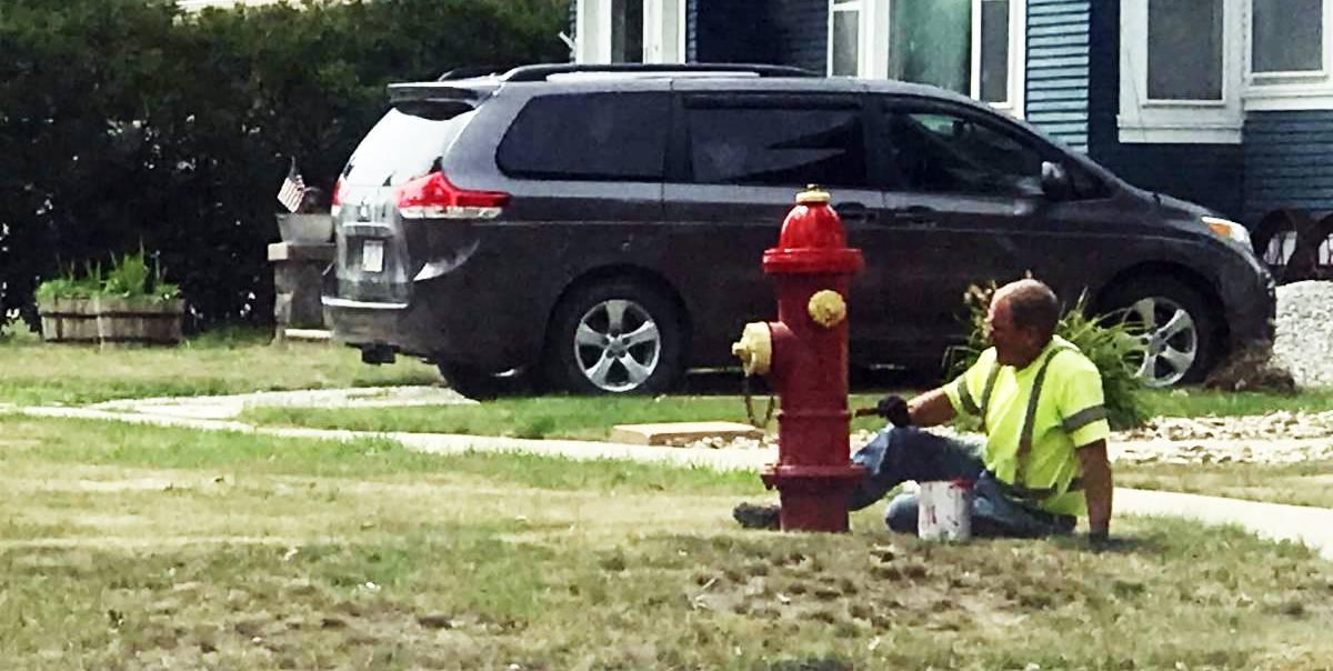 Chad Newton of the Vinton Water Department painting one of the hydrants along C Ave.