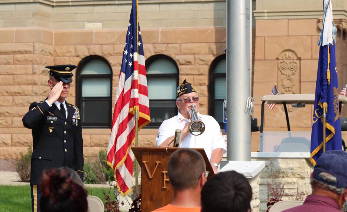 SGM Pete Mueller salutes as legion member Craig Streeter plays Taps closing the 9/11 memorial