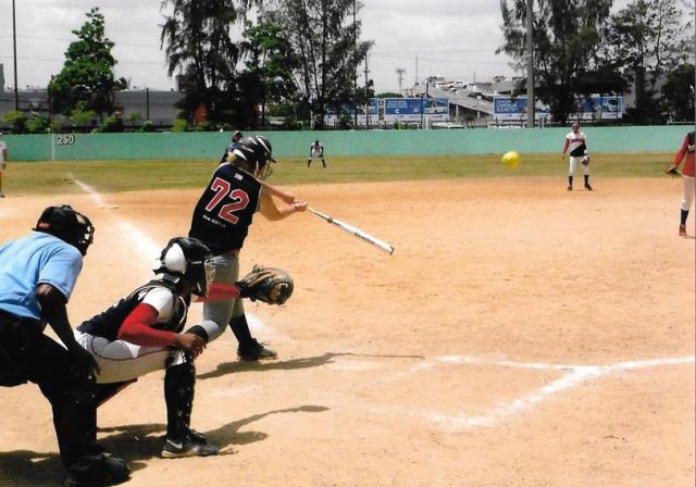 Andrea Wagoner connects on a pitch during a game in the Dominican Republic.