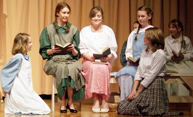Anne (Melissa Underwood) reads to the girls in V-S HSAP play, which opens at 7 p.m. Friday