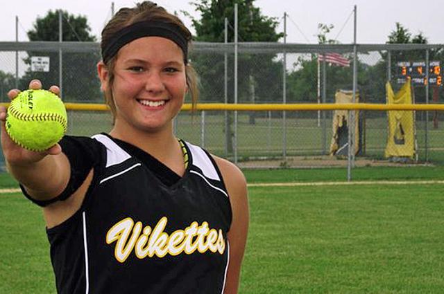 Ashley Strong holds the softball she hit over the fence for a game-winning homer Saturday.