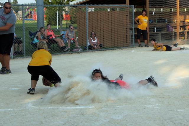 Alumni softball:Ashley Strong got a faceful of dust, but scored to help the black team win.