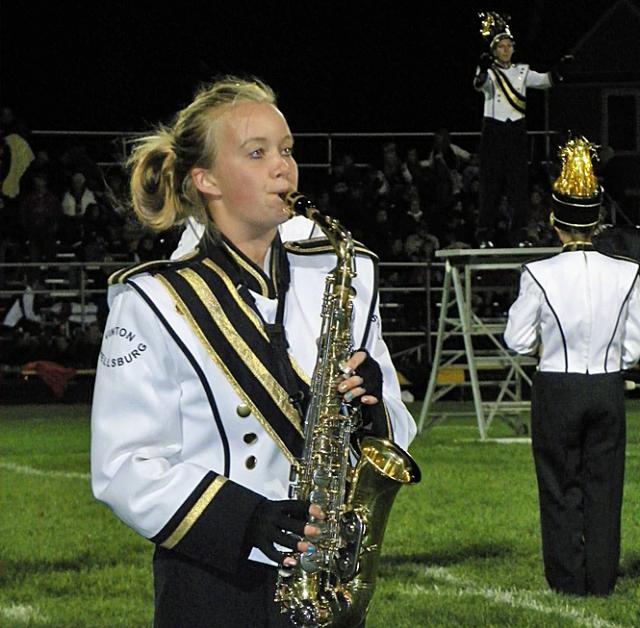 Sara Jorgensen plays a sax solo as the band begins its final halftime show.