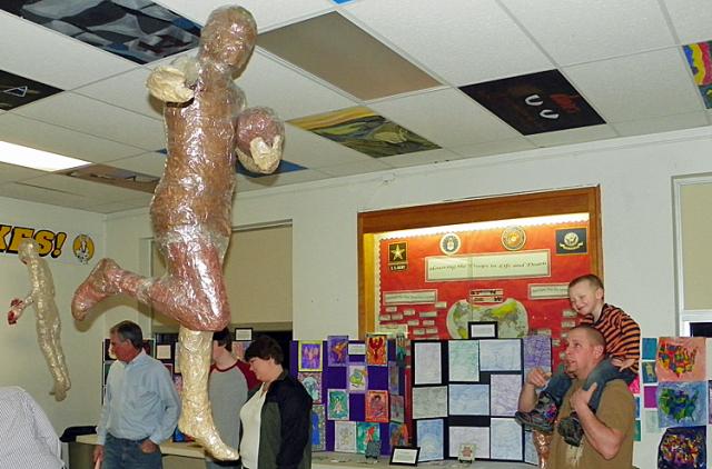 Wyatt Walker admires the art while sitting on Dad Okie's shoulders.