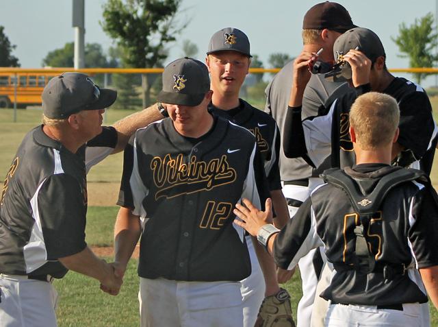 Coach Jim Struve, catcher Aaron Henderson and the Vikings congratulate Daniel Ervin on his victory.
