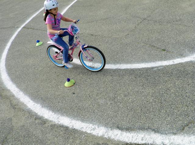 Haley Englebert weaves between obstacles during the VPRD Bike Safety Rodeo.