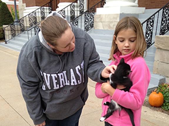 Pastor Jessica blesses a kitten held by Sara Johnson at the 2014 Blessing of the Animals service