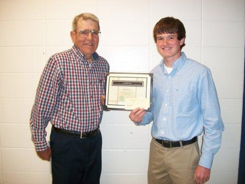Commissioner Robert Ritscher presents James Brecht with Benton SWCD Scholarship Award.
