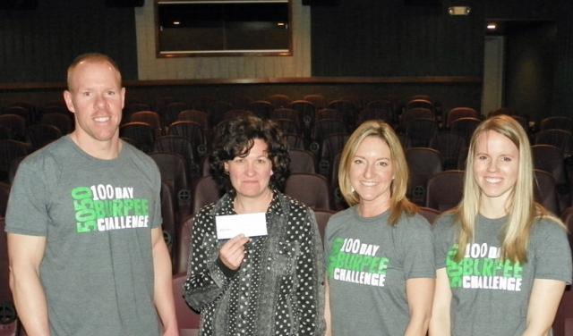 Marcy Horst accepts the $1,710 check from Mark Erickson, Julie Lessig and Alexa Schirm.