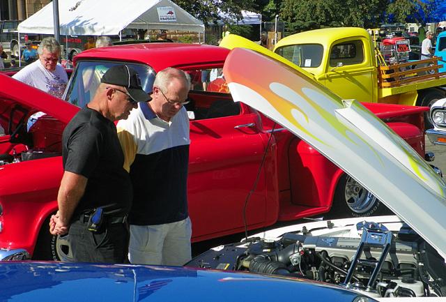 Spectators look under the hood of one of the hundreds of entries in the 2013 Vinton Cruise.