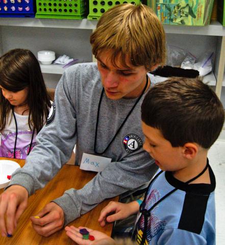 Max Krohe helping the children with a project.