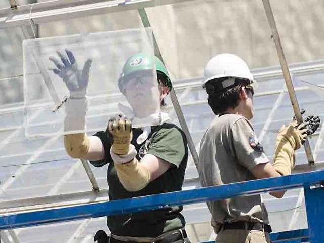 artha Mickleson removing a sheet of glass