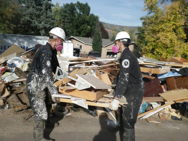 Cedar 4's Patrick and Alan haul boards out of an flood-affected home in Colorado.