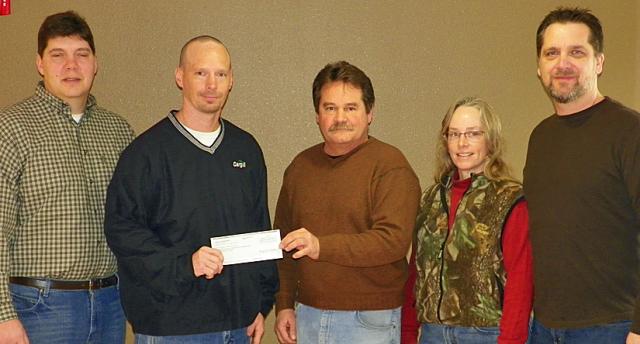 Conservation Board members accept the $50,000 donation from Cargill's Tom Stueck.