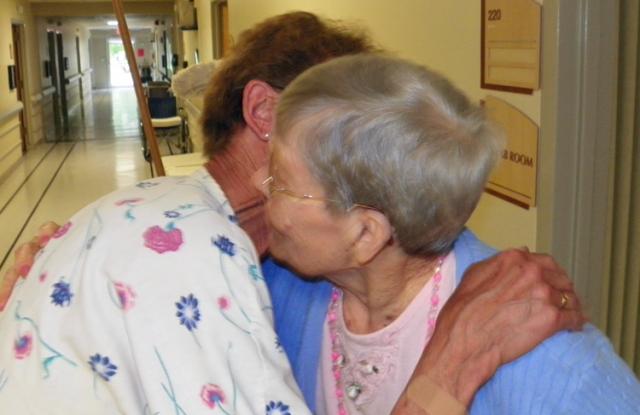 Resident Franny Porter gives Carol Salger a hug & kiss after learning she received a 50-year honor.