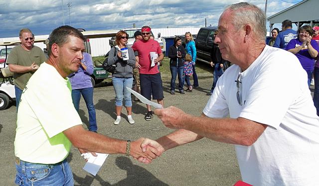 Bob Baumann accepts the prize on behalf of Triple Threat teammates Chad Meyer and John Sellman.