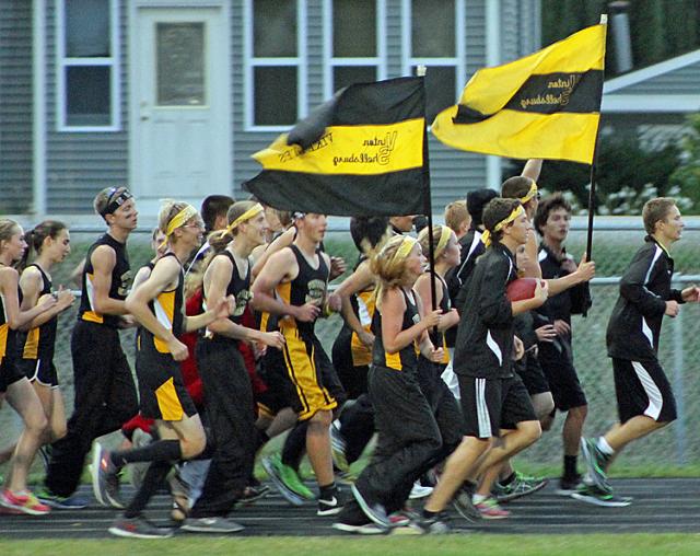 Jacob Bunge carries the ball as the VS CC runners circle the track.