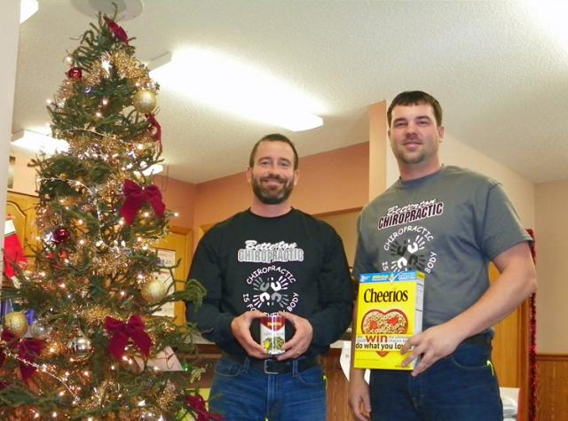 Matt Betteron, left, and Scott Barron pose with food donations during today's annual food drive.