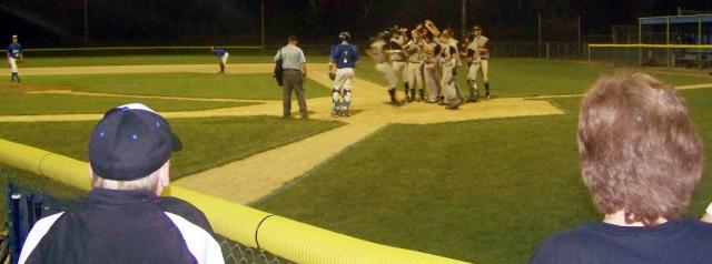 Vikings celebrate at home plate after Clint Ferguson's 2-run homer in inning 5 of Game 2.