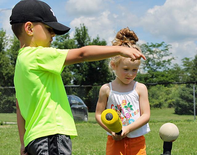 Landon Wygle offers Tenli Libbert some hitting advice during the VPRD Blastball session on Tuesday.