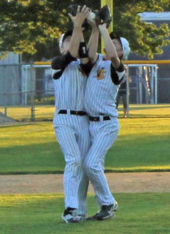 Vike pitcher Ty Rippel and 3B Scott Wirth collide as they pursue a pop-up. Rippel caught the ball.