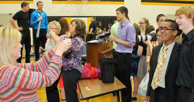 Mr. Mohlis posed with photos of many choir members after the Choral Night event.