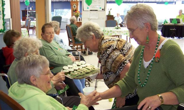 Mary Simnacher and Linda Rouse serve Trudy Pribbenow.