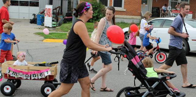 Familes make their way down 4th Street during the Kiddie Parade.