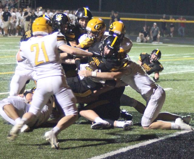 Curtis Erickson (1) battles for yardage.
