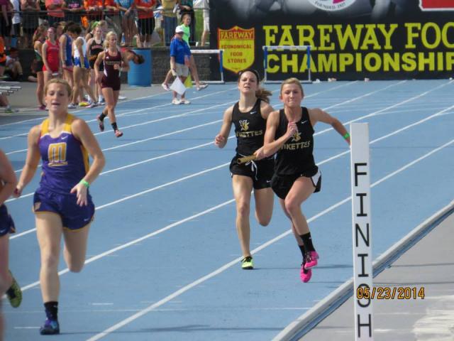 Dawne Schminke prepares to hand the baton to Payton Leonard in the 4 x 200.