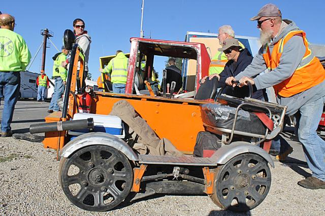 Darrel Christy of Vinton pushes his railroad maintenance car to the tracks for the Saturday ride.