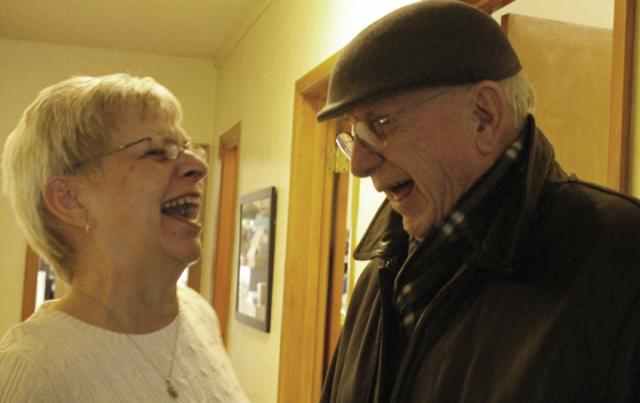 Deb Christianson shares a laugh with Keith Ervin at her Retirement Open House on Friday
