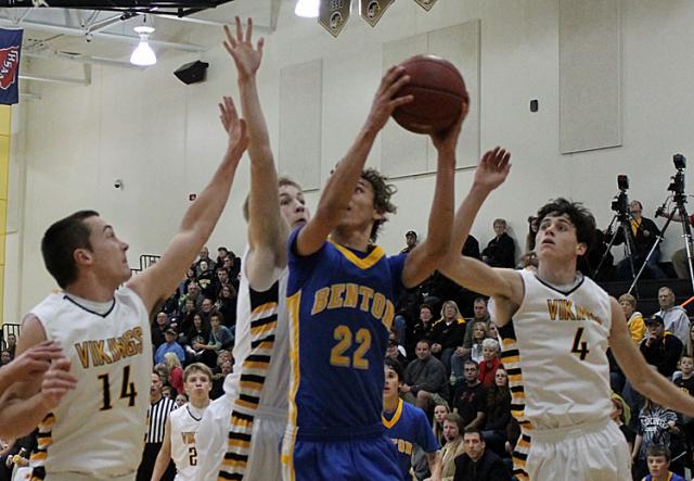 Chase Overton, Max Kearns and Grant Sagan try to stop a Bobcat from scoring; the Vikes won, 70-55.