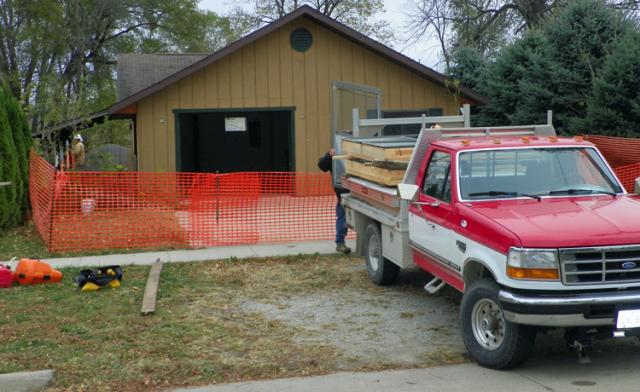 Workers from D.W. Zinser prepare to demolish this home on A Avenue near the river.